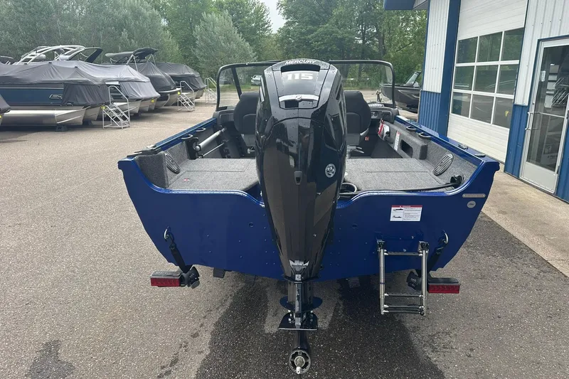 Slide: The Image of 2025 Crestliner 1750 Hawk boat with Mercury 115 engine, parked outdoors. - 6