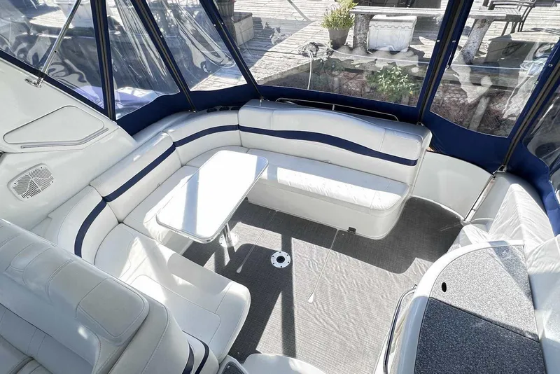 Slide: The Image of 2007 Formula 40 Performance Cruiser interior with white seating and table, enclosed by blue canopy. - 10