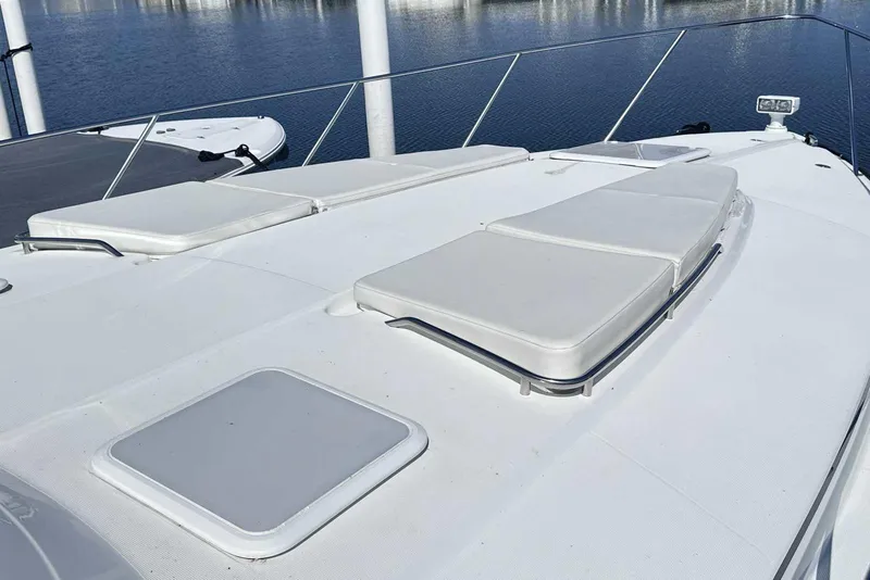 Slide: The Image of 2007 Formula 40 Performance Cruiser deck with sun pads, docked by calm water. - 2