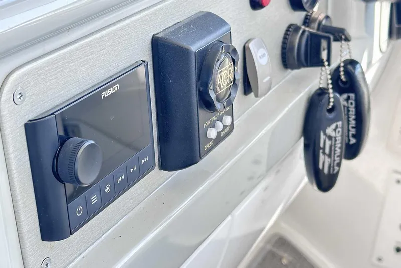 Slide: The Image of Control panel of a 2007 Formula 40 Performance Cruiser with keys and audio system. - 20