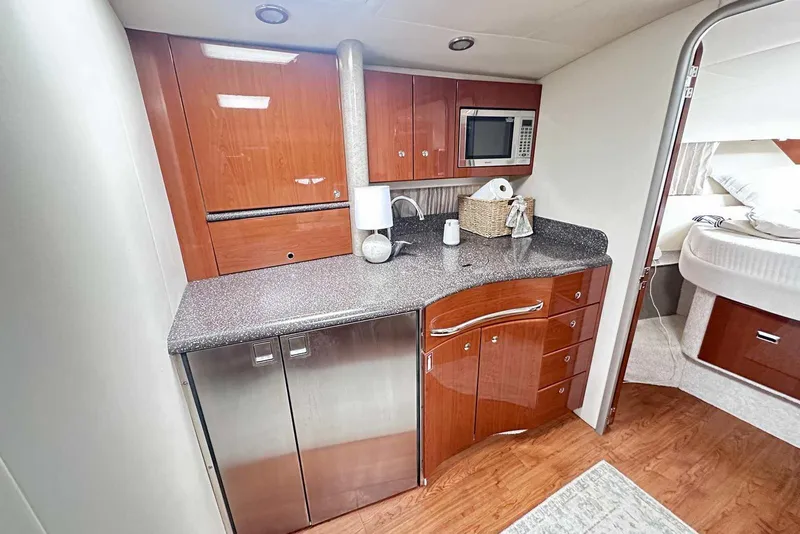 Slide: The Image of Luxurious 2007 Formula 40 Performance Cruiser kitchen with wood cabinetry and modern appliances. - 25