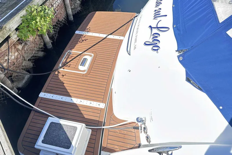 Slide: The Image of 2007 Formula 40 Performance Cruiser docked, featuring teak deck and blue cover. - 3