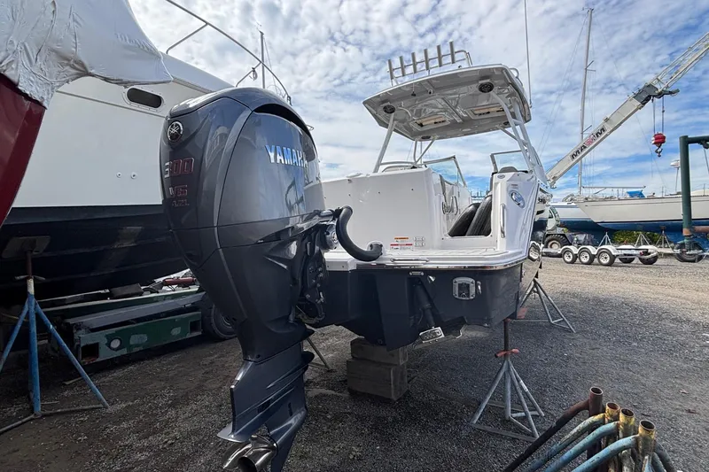 Slide: The Image of 2024 Solara S-250 DC boat with Yamaha 300 V6 engine in a boatyard setting. - 4