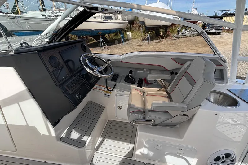 Slide: The Image of 2024 Solara S-250 DC boat cockpit with modern steering and comfortable seating. - 8