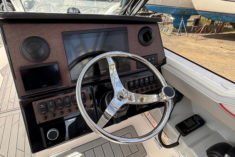 Slide: The Image of 2024 Solara S-250 DC boat dashboard with steering wheel and control panel. - 9