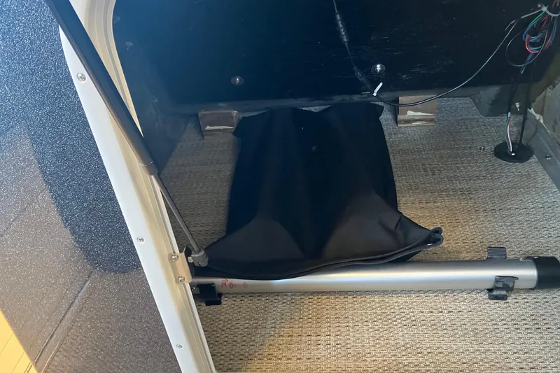 Slide: The Image of Interior view of 2026 Crest Continental 250 SLC storage compartment with wiring and carpeted floor. - 13