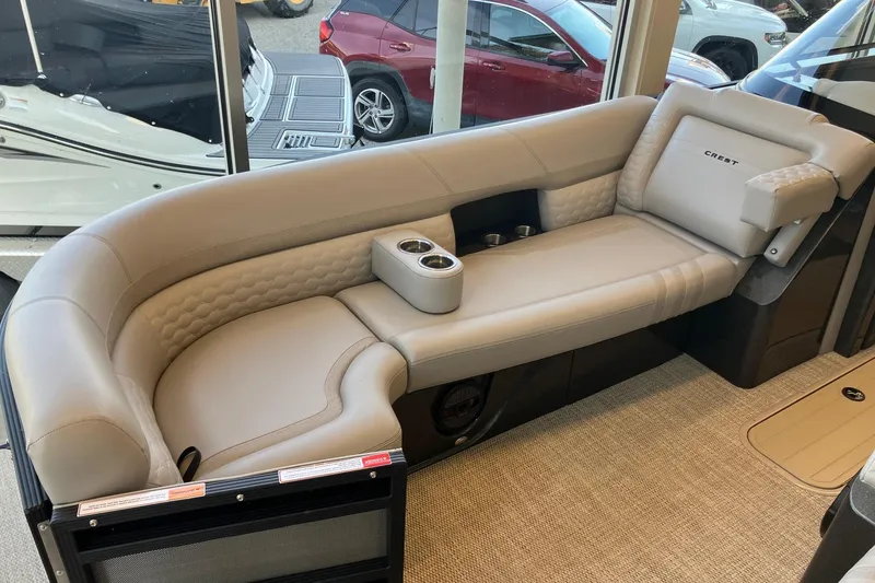 Slide: The Image of Luxurious seating in 2026 Crest Continental 250 SLC boat, featuring plush upholstery and cup holders. - 16