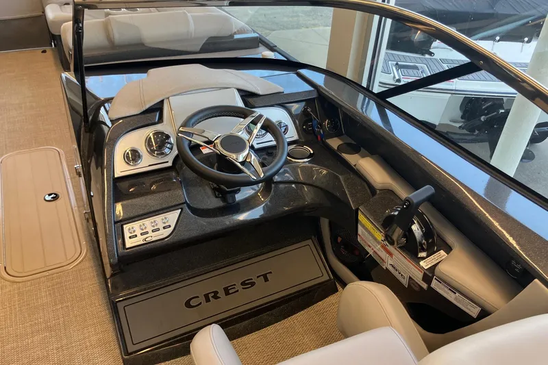Slide: The Image of 2026 Crest Continental 250 SLC boat dashboard with steering wheel and controls. - 8