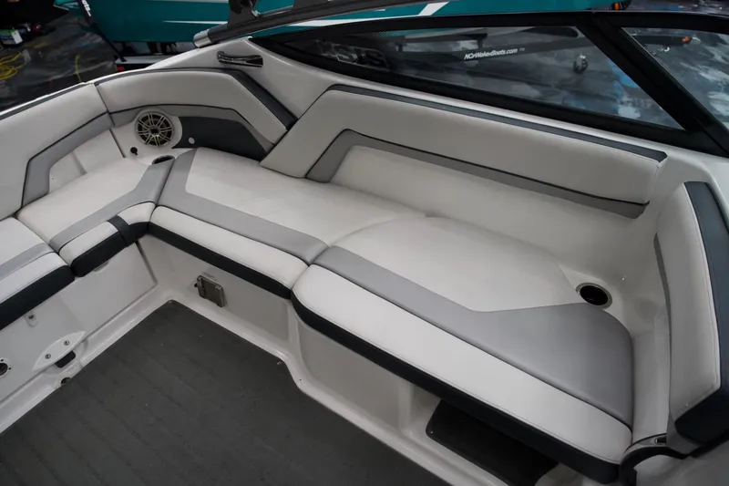 Slide: The Image of 2015 Yamaha Boats 212X interior seating with sleek gray and white upholstery. - 13