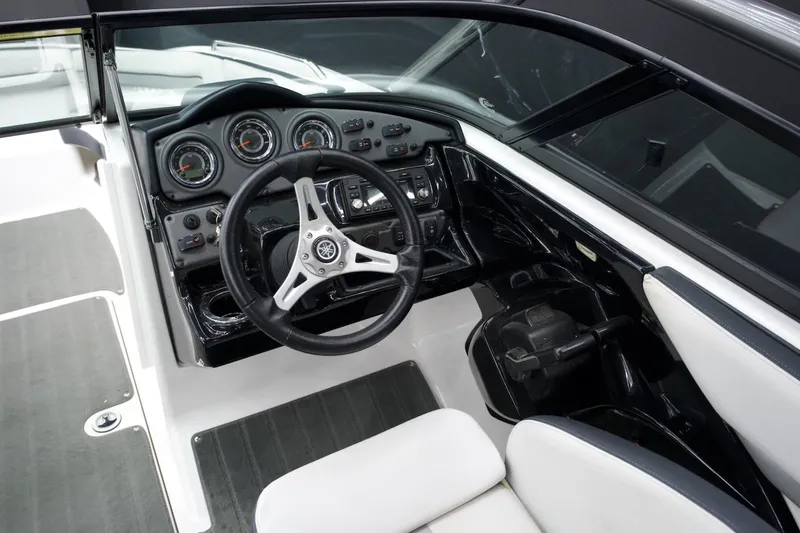 Slide: The Image of 2015 Yamaha Boats 212X cockpit with steering wheel and dashboard controls. - 8