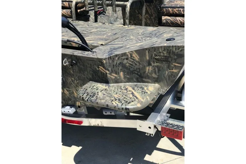 Slide: The Image of 2026 War Eagle Blackhawk 961 boat with camouflage design on a trailer. - 12