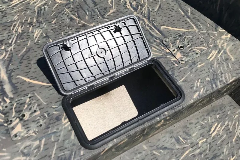 Slide: The Image of Open storage compartment on 2026 War Eagle Blackhawk 961 boat with camo pattern. - 4