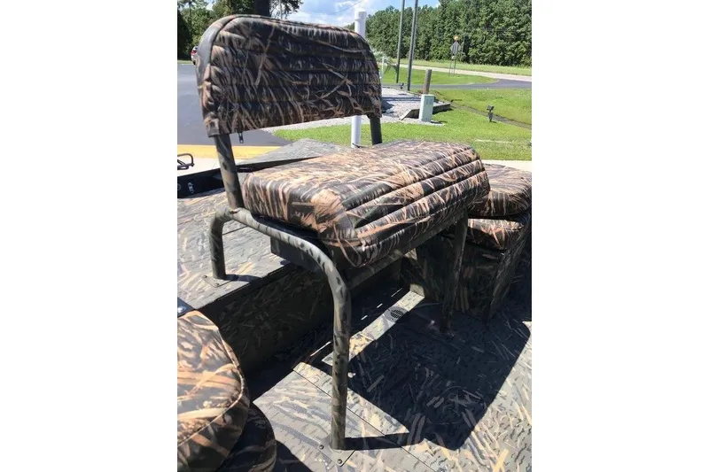 Slide: The Image of Camo seating on 2026 War Eagle Blackhawk 961 boat, outdoors in sunny setting. - 6