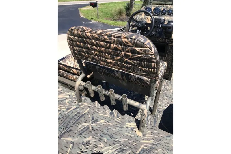 Slide: The Image of Camouflage interior of 2026 War Eagle Blackhawk 961 boat with rod holders and steering wheel. - 7