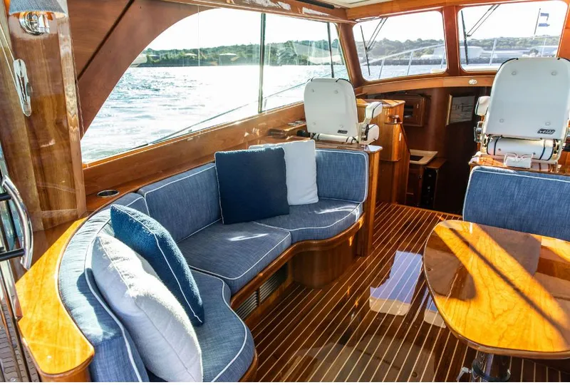 Slide: The Image of Luxurious 2013 Hinckley Talaria 48 MY yacht interior with elegant seating and wooden finishes. - 11