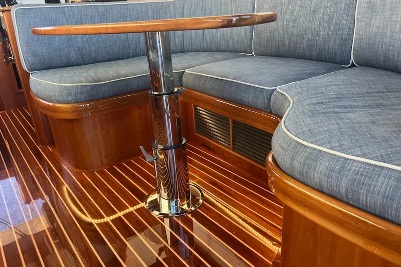 Slide: The Image of Luxurious interior of 2013 Hinckley Talaria 48 MY with polished wood and cushioned seating. - 13