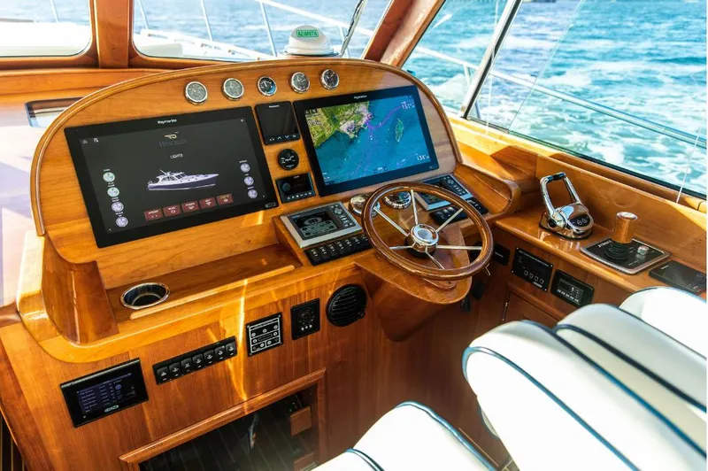 Slide: The Image of Helm of 2013 Hinckley Talaria 48 MY yacht with navigation screens and wooden steering wheel. - 16