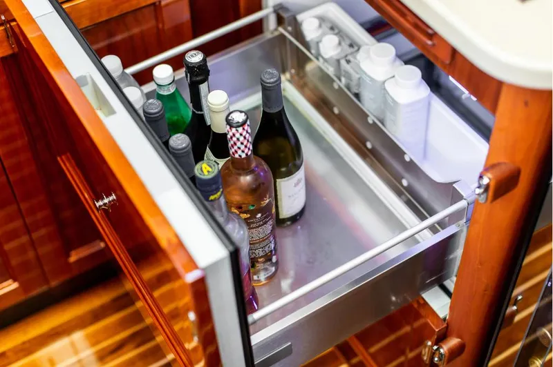 Slide: The Image of Open drawer with assorted bottles in a 2013 Hinckley Talaria 48 MY yacht interior. - 22