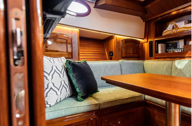 Slide: The Image of Interior of 2013 Hinckley Talaria 48 MY yacht with elegant wood finish and cozy seating. - 25