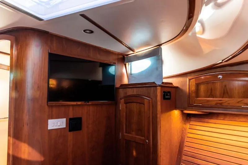 Slide: The Image of Luxurious interior of 2013 Hinckley Talaria 48 MY yacht with wood paneling and TV. - 29
