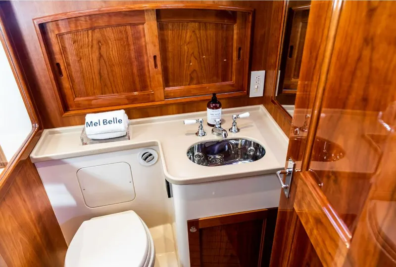 Slide: The Image of Luxurious 2013 Hinckley Talaria 48 MY yacht bathroom with wooden cabinetry and modern fixtures. - 30