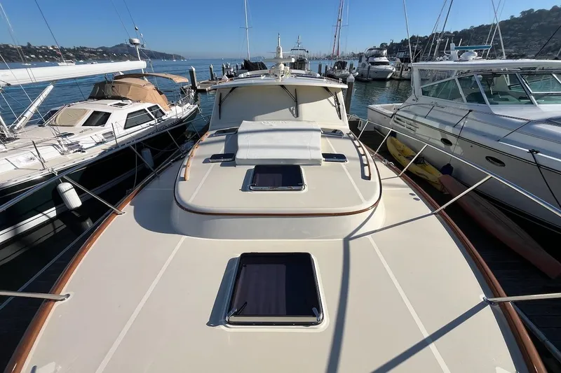 Slide: The Image of 2013 Hinckley Talaria 48 MY yacht docked among other boats in a marina. - 35