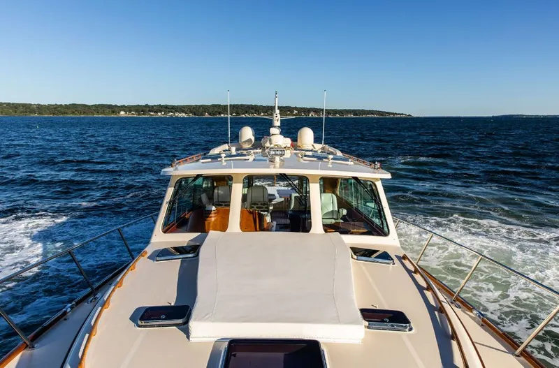 Slide: The Image of Hinckley Talaria 48 MY 2013 cruising on open water under clear blue skies. - 39