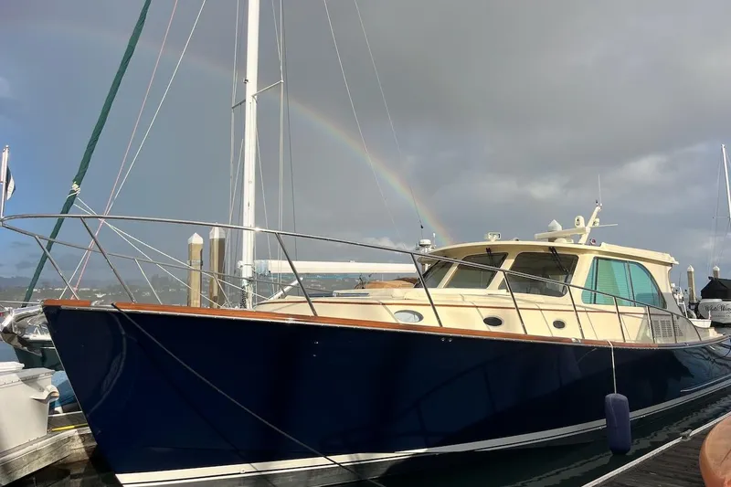 Slide: The Image of 2013 Hinckley Talaria 48 MY yacht docked with a rainbow in the background. - 42