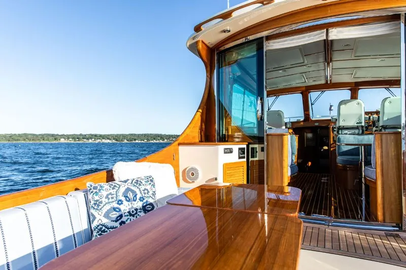 Slide: The Image of Luxurious 2013 Hinckley Talaria 48 MY yacht interior with elegant wood finish and scenic ocean view. - 5
