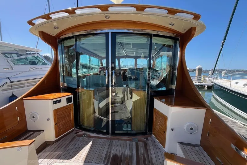 Slide: The Image of 2013 Hinckley Talaria 48 MY yacht with elegant wooden deck and glass doors. - 9