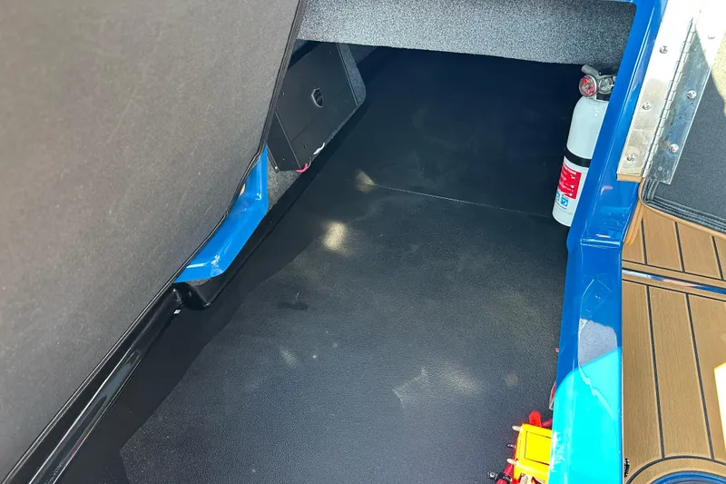 Slide: The Image of 2022 Moomba Makai interior storage area with fire extinguisher and blue accents. - 13