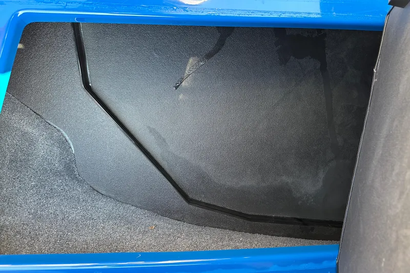 Slide: The Image of 2022 Moomba Makai boat storage compartment with blue trim and black interior. - 17