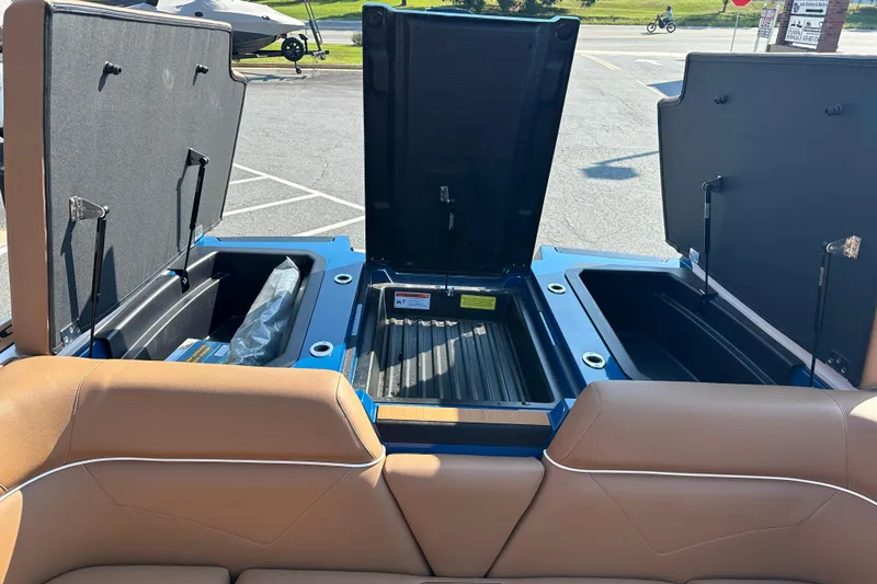 Slide: The Image of 2022 Moomba Makai boat storage compartments open, showcasing spacious interior design. - 18