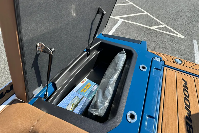 Slide: The Image of 2022 Moomba Makai boat storage compartment open, revealing interior contents. - 20