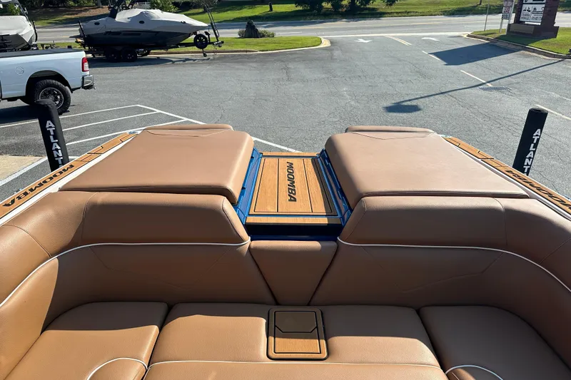 Slide: The Image of 2022 Moomba Makai boat interior with tan leather seating and branded deck. - 22