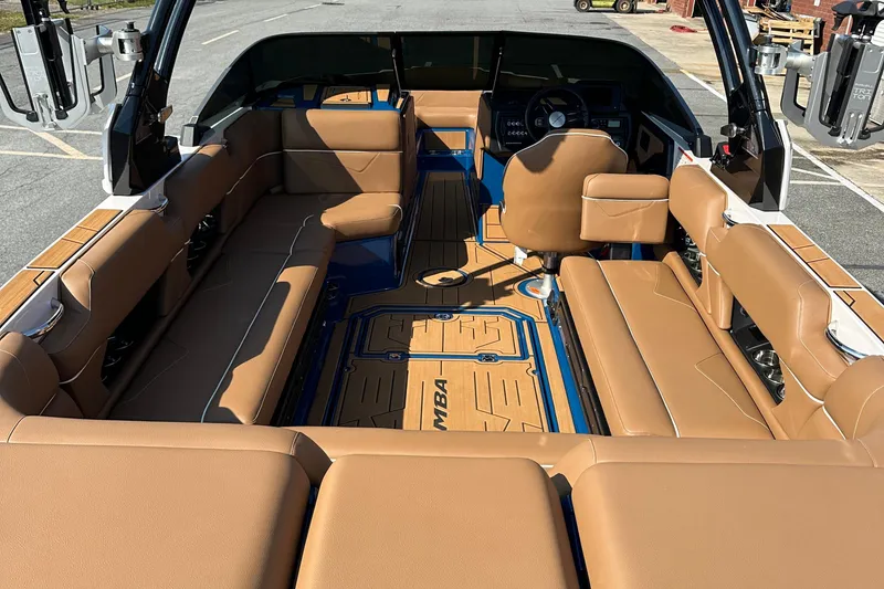 Slide: The Image of 2022 Moomba Makai boat interior with tan seating and blue accents. - 24