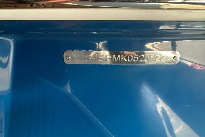 Slide: The Image of 2022 Moomba Makai boat hull identification number on blue surface. - 25