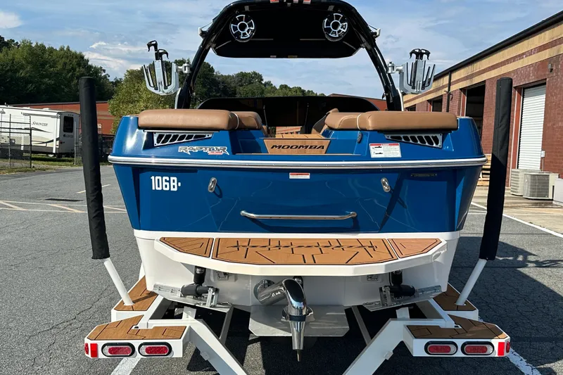 Slide: The Image of 2022 Moomba Makai boat, blue exterior, on trailer, parked outdoors. - 5