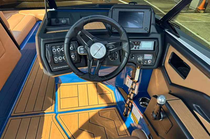 Slide: The Image of 2022 Moomba Makai boat dashboard with steering wheel and control panel. - 7