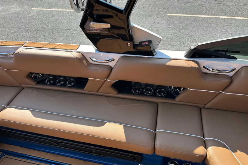 Slide: The Image of 2022 Moomba Makai boat interior with tan leather seating and cup holders. - 8