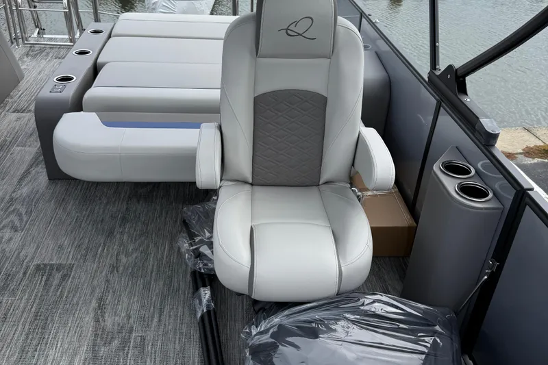 Slide: The Image of Luxurious seating on 2026 Qwest Splash Pad E-Class boat with cup holders and modern design. - 3