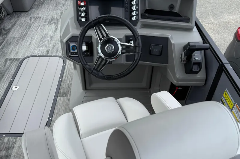 Slide: The Image of 2026 Qwest Splash Pad E-Class boat cockpit with modern steering and controls. - 5