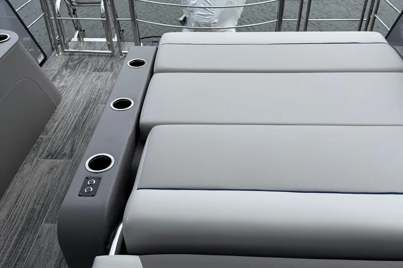 Slide: The Image of Luxurious seating on 2026 Qwest Splash Pad E-Class boat with cup holders and sleek design. - 6