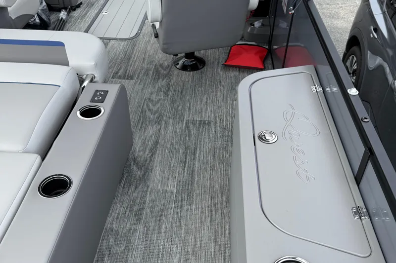 Slide: The Image of Interior of 2026 Qwest Splash Pad E-Class boat with seating and cup holders. - 7