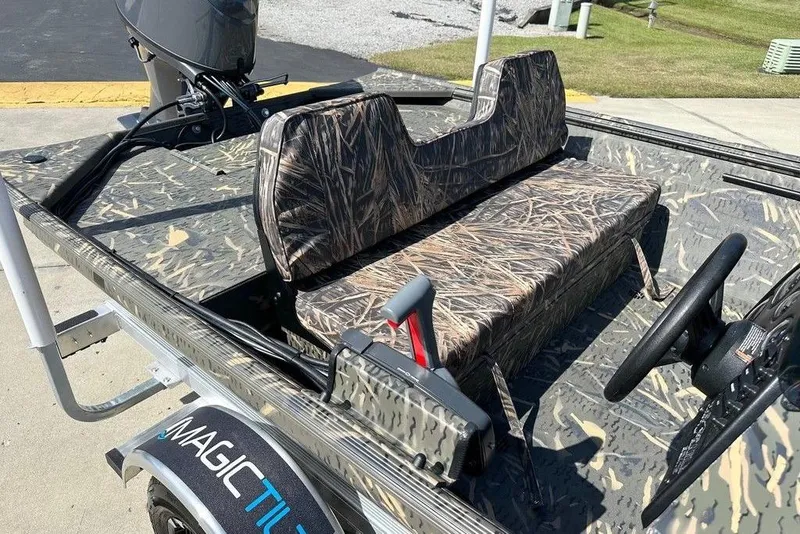 Slide: The Image of 2026 War Eagle 754LDSV boat with camouflage seating and steering, on a Magic Tilt trailer. - 6