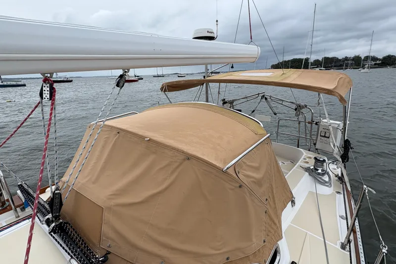 Slide: The Image of 2007 Tartan 3700 CCR sailboat with tan covers, docked on a cloudy day. - 10