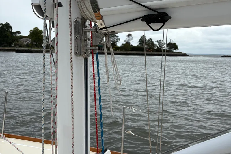 Slide: The Image of Sailboat rigging on a 2007 Tartan 3700 CCR, with coastal view in the background. - 12