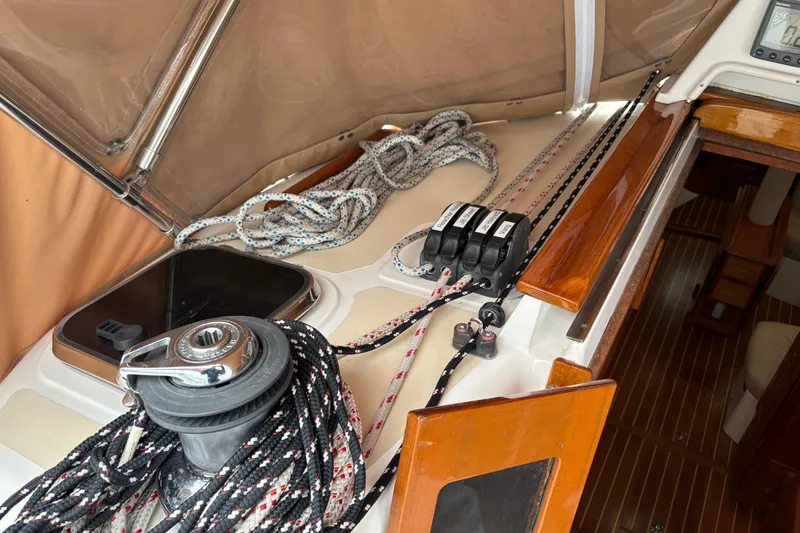 Slide: The Image of 2007 Tartan 3700 CCR sailboat deck with winch, ropes, and wooden trim. - 14