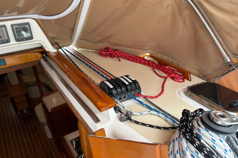 Slide: The Image of Interior view of a 2007 Tartan 3700 CCR sailboat cockpit with ropes and navigation instruments. - 15