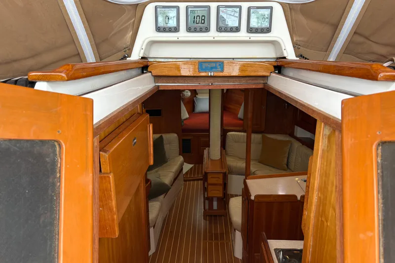 Slide: The Image of Interior of 2007 Tartan 3700 CCR sailboat with wood finish and cozy seating area. - 17